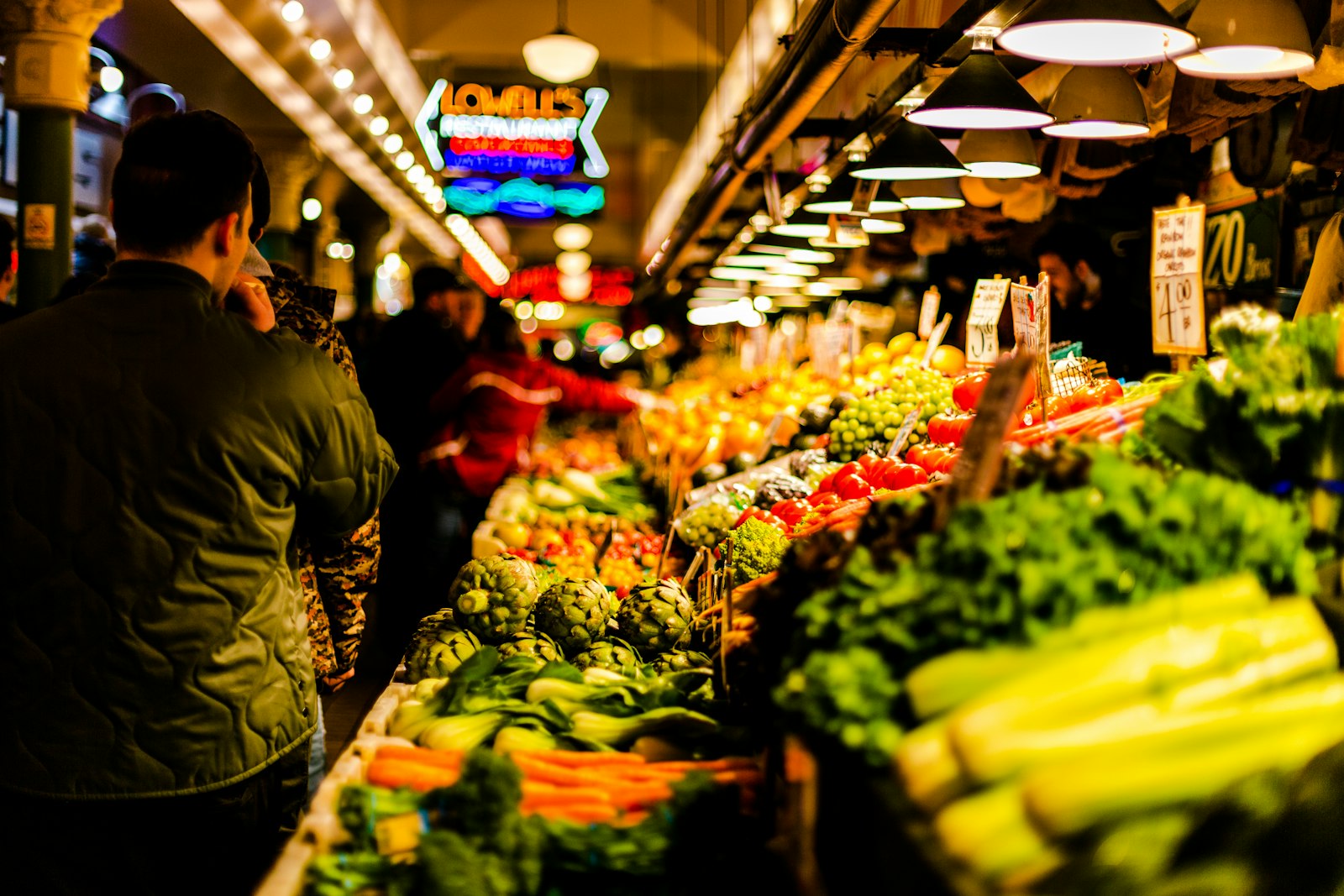 A vibrant, colorful city market lined with fresh produce stalls